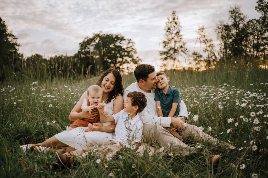 Family of five sitting in the field in Portland, OR