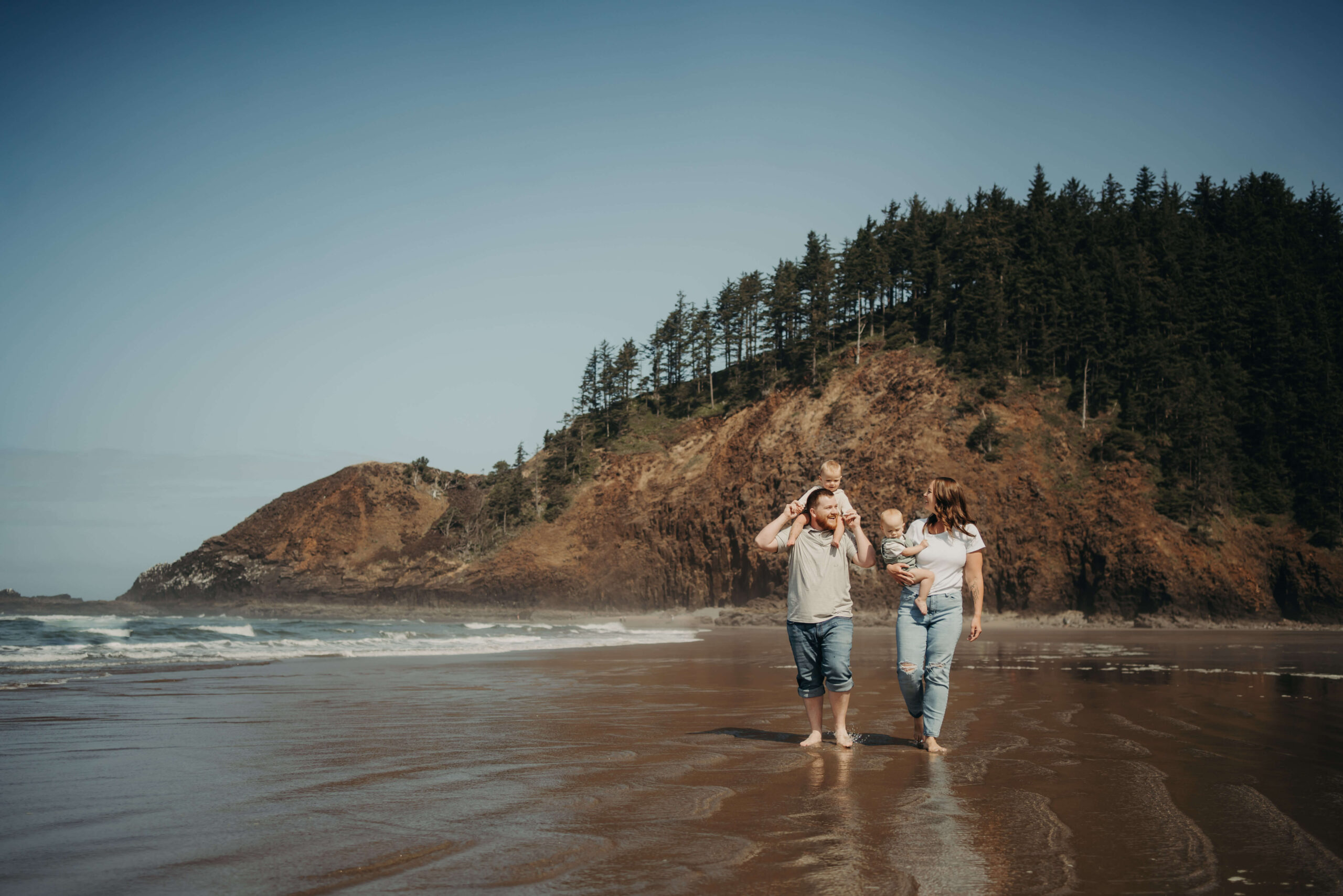 Family of four walking at the beach