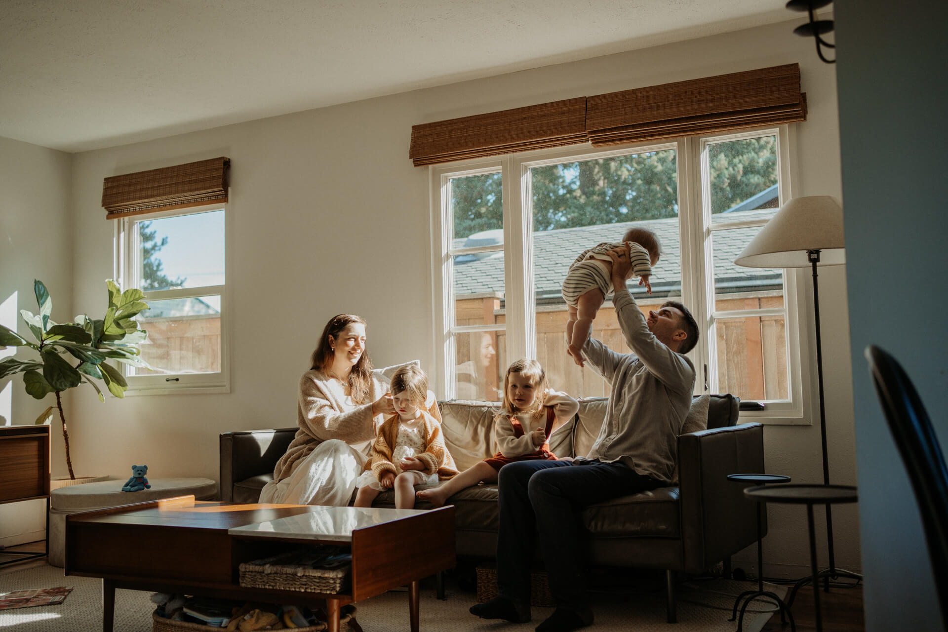 Family of 5 relaxing on their couch at their home